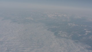 WA002_040 - 4K stock footage aerial video tilt from heavy cloud cover to reveal the Sierra Nevada Mountains, California