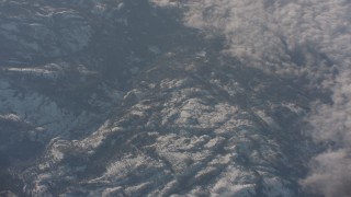 WA002_047 - 4K stock footage aerial video of snowy mountains by the edge of cloud cover in the Sierra Nevada Mountains, California
