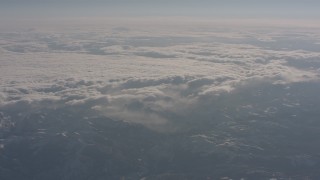 WA002_048 - 4K stock footage aerial video of clouds rolling over snowy mountains in the Sierra Nevada Mountains, California