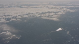 WA002_050 - 4K stock footage aerial video of snowy mountains and a pair of lakes near dense cloud layer in the Sierra Nevada Mountains, California