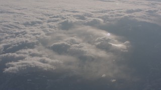 WA002_052 - 4K stock footage aerial video of misty clouds above snowy Sierra Nevada Mountains, California