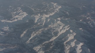 WA002_055 - 4K stock footage aerial video of a reverse view of snow-covered ridges in the Sierra Nevada Mountains, California