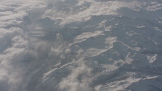 WA002_057 - 4K stock footage aerial video of dense cloud cover and snowy mountains, Sierra Nevada Mountains, California