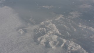 WA002_074 - 4K stock footage aerial video of Lake Tahoe and snowy mountains by a bank of clouds, California
