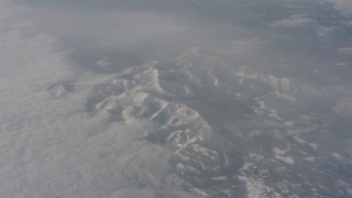WA002_075 - 4K stock footage aerial video of Sierra Nevada Mountains below misty clouds, California