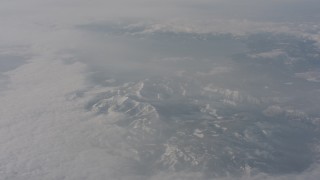 WA002_077 - 4K stock footage aerial video tilt from clouds to reveal the Sierra Nevada Mountains, California