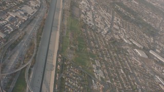 WA003_023 - 4K stock footage aerial video pan across I-105 and I-710 interchange by Los Angeles River in Downey, reveal Lynwood suburbs, California