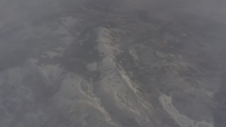 WA004_008 - 4K stock footage aerial video bird's eye view of snowy mountain ridge and misty clouds in Lassen County, California