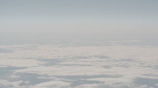 WA004_027 - 4K stock footage aerial video track a jet airplane flying over cloud cover in Lake County, Oregon