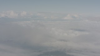WA004_031 - 4K stock footage aerial video of flying through mist to reveal white cloud cover over Lake County, Oregon