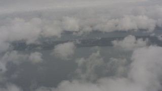 WA004_037 - 4K stock footage aerial video fly over clouds to reveal Puget Sound, Washington