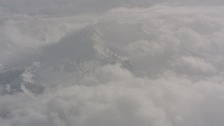 WA004_074 - 4K stock footage aerial video fly over clouds to approach Mount St. Helens with snow in Washington