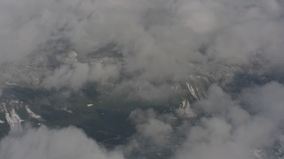 WA004_076 - 4K stock footage aerial video fly over clouds and snowy mountains in Skamania County, Washington