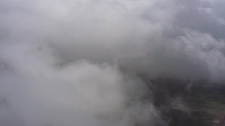 WA005_026 - 4K stock footage aerial video fly into dense white cloud cover over Southern California