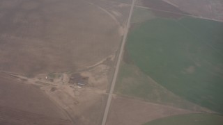 WA005_030 - 4K stock footage aerial video reverse view of clouds revealing circular crop fields below in Kansas