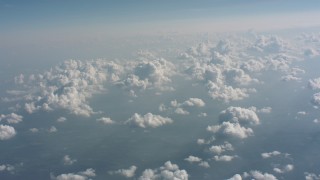 WA005_099 - 4K stock footage aerial video tilt from clouds over countryside to a wider view of cloud cover over West Virginia