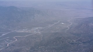 WA007_030 - 4K stock footage aerial video of a reverse view of the town of Cabazon and mountains, California