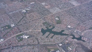WA007_036 - 4K stock footage aerial video of a bird's eye view of suburban neighborhoods and lake in Moreno Valley, California