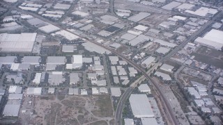 WA007_049 - 4K stock footage aerial video of railroad tracks and warehouse buildings in Santa Fe Springs, California