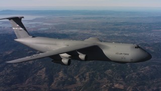 WAAF01_C007_01172T - 4K stock footage aerial video of tracking a Lockheed C-5 flying over hills in Northern California