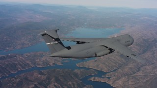 WAAF01_C008_0117M6 - 4K stock footage aerial video of a Lockheed C-5 in flight near a lake in Northern California