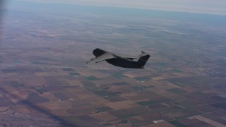 WAAF01_C009_0117WH - 4K stock footage aerial video of tracking a Lockheed C-5 flying over farmland in Northern California