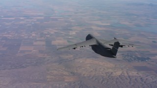 WAAF01_C013_0117XK - 4K stock footage aerial video of tracking a Lockheed C-5 flying over hills near farmland in Northern California