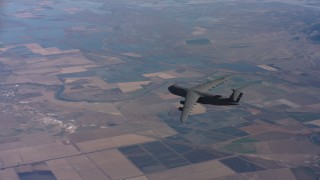 WAAF01_C017_011717 - 4K stock footage aerial video of tracking a Lockheed C-5 jet flying over farmland in Northern California