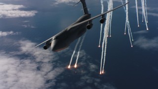 WAAF01_C050_0117XT - 4K stock footage aerial video of passing a Lockheed C-5 dropping flares over the ocean in Northern California