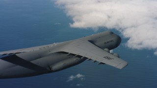 WAAF01_C058_01171J_S000 - 4K stock footage aerial video of flying beside a Lockheed C-5 as it leaves frame in Northern California