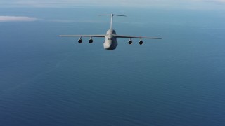 WAAF01_C066_01178K - 4K stock footage aerial video of a reverse view of a Lockheed C-5 flying over the ocean in Northern California