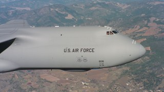 WAAF01_C071_0117GR - 4K stock footage aerial video of the front end and cockpit of a Lockheed C-5 over Northern California