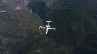 WAAF02_C019_0117JN - 4K stock footage aerial video of a reverse view of mountains, revealing a Learjet C-21 in flight over Northern California 