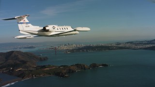 WAAF02_C051_01170K_S000 - 4K stock footage aerial video of a Learjet C-21 near Marin Hills, Golden Gate Bridge and San Francisco, California