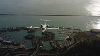 WAAF02_C054_0117PF_S000 - 4K stock footage aerial video of a reverse view of a Learjet C-21 flying over the bay in Northern California
