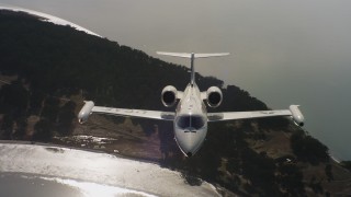 WAAF02_C056_011763 - 4K stock footage aerial video a reverse view of a Learjet C-21 flying over a bay in Northern California