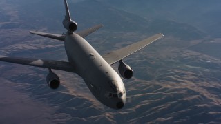WAAF03_C014_01184M - 4K stock footage aerial video of flying by a McDonnell Douglas KC-10 in flight over hills and farms in Northern California