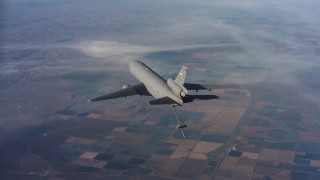 WAAF03_C018_011858 - 4K stock footage aerial video of flying around a McDonnell Douglas KC-10 lowering the refueling boom, Northern California