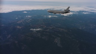 WAAF03_C030_0118EM - 4K stock footage aerial video of a McDonnell Douglas KC-10 in flight over mountains in Northern California