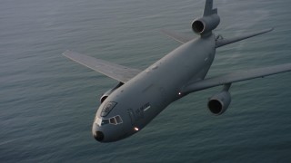 WAAF03_C044_01181Q - Aerial stock footage of 4K aerial ideo of flying around the nose of a McDonnell Douglas KC-10 over the ocean in Northern California