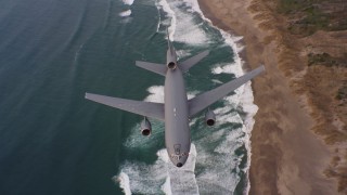 WAAF03_C055_01189Q - 4K stock footage aerial video of a reverse view of a McDonnell Douglas KC-10 flying over beaches in Northern California