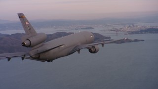 WAAF03_C058_0118S0 - 4K stock footage aerial video of a McDonnell Douglas KC-10 approaching San Francisco, California at sunset