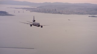 WAAF03_C061_011840 - 4K stock footage aerial video of a McDonnell Douglas KC-10 in flight near San Francisco, California at sunset