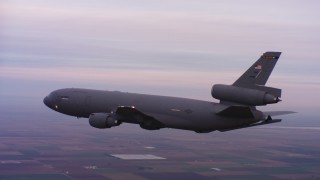 WAAF03_C069_01185P - 4K stock footage aerial video of a McDonnell Douglas KC-10 flying over farms at sunset in Northern California