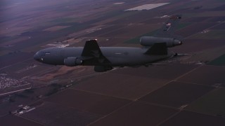 WAAF03_C070_0118QG - 4K stock footage aerial video of a McDonnell Douglas KC-10 in flight over farmland at sunset in Northern California