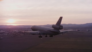 WAAF03_C074_0118AU - 4K stock footage aerial video of a McDonnell Douglas KC-10 approaching Travis Air Force Base at sunset, California