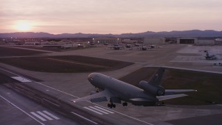 WAAF03_C074_0118AU_S000 - 4K stock footage aerial video of a McDonnell Douglas KC-10 landing at Travis Air Force Base at sunset, California