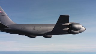 WAAF04_C009_011857 - 4K stock footage aerial video of a Boeing KC-135 flying by hazy skies in Northern California