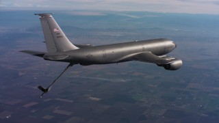 WAAF04_C011_0118FR - 4K stock footage aerial video of a Boeing KC-135 flying with lowered refueling boom in Northern California