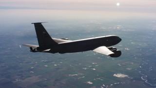 WAAF04_C015_0118WU - 4K stock footage aerial video of a Boeing KC-135 flying over farmland in Northern California